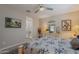 Bright bedroom with a ceiling fan, area rug and a view to the bathroom at 17219 W La Luz Rd, Surprise, AZ 85387