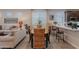 Dining area next to a kitchen features modern décor, neutral tones, and lots of natural light at 17219 W La Luz Rd, Surprise, AZ 85387