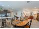 Inviting dining area showcases a wooden table, bar seating, and elegant décor; perfect for entertaining or casual Gathering meals at 17219 W La Luz Rd, Surprise, AZ 85387