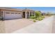 Inviting home exterior with brick driveway, well-kept landscaping, and a two-car garage at 17219 W La Luz Rd, Surprise, AZ 85387