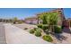 Suburban home with three-car garage, landscaped yard and walkway at 17219 W La Luz Rd, Surprise, AZ 85387
