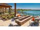 Outdoor fire pit with comfortable seating overlooking a scenic lake at 17219 W La Luz Rd, Surprise, AZ 85387