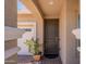 Arched front entryway with decorative columns and a view of the garage at 17219 W La Luz Rd, Surprise, AZ 85387