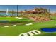 Golf course by the water with palm trees and villas in the background at 17219 W La Luz Rd, Surprise, AZ 85387