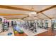 Modern gym with wood floors, high ceilings with beams, and plenty of equipment at 17219 W La Luz Rd, Surprise, AZ 85387