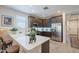 Bright kitchen featuring a large quartz countertop island, dark cabinetry, and stainless steel appliances for cooking at 17219 W La Luz Rd, Surprise, AZ 85387