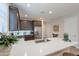 Stylish kitchen featuring quartz countertops, dark wood cabinets, and stainless steel appliances, perfect for cooking at 17219 W La Luz Rd, Surprise, AZ 85387