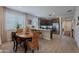 Eat-in kitchen with stainless appliances, dark cabinets, white countertops, and an adjacent dining area at 17219 W La Luz Rd, Surprise, AZ 85387