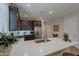 Beautiful kitchen with stainless appliances, dark cabinets, a large sink, and white quartz countertops at 17219 W La Luz Rd, Surprise, AZ 85387