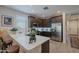 Stylish kitchen features stainless steel appliances, dark wood cabinets, and a bright white quartz countertop at 17219 W La Luz Rd, Surprise, AZ 85387