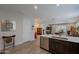 Bright kitchen featuring stainless appliances, dark cabinets, quartz counters, and an open view to the living area at 17219 W La Luz Rd, Surprise, AZ 85387