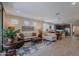 Open concept living room leading into the kitchen and dining areas, featuring neutral tones and tile flooring at 17219 W La Luz Rd, Surprise, AZ 85387