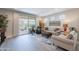 Bright living room with sliding glass doors to the patio, comfortable seating, and neutral colors creating an inviting space at 17219 W La Luz Rd, Surprise, AZ 85387