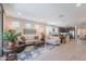 Spacious open-concept living room with stylish furnishings, tile flooring, and plenty of natural light, adjacent to the kitchen at 17219 W La Luz Rd, Surprise, AZ 85387