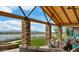 Community lounge with comfortable seating, fireplace, and views of a lake at 17219 W La Luz Rd, Surprise, AZ 85387