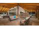Spacious covered community lounge featuring stone pillars, ceiling fans, and multiple seating areas at 17219 W La Luz Rd, Surprise, AZ 85387