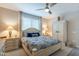 Serene main bedroom with a ceiling fan, natural light, and calming décor to create a relaxing retreat for rest and rejuvenation at 17219 W La Luz Rd, Surprise, AZ 85387