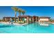 Beautiful community pool with ample lounge seating and shaded areas under a blue sky at 17219 W La Luz Rd, Surprise, AZ 85387