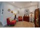 Cozy sitting room with red armchairs, decorative art, and warm lighting at 17219 W La Luz Rd, Surprise, AZ 85387