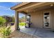 Covered back patio with a grill, outdoor dining area, and landscaped backyard at 1725 E Chanute Pass --, Phoenix, AZ 85040