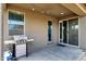 Covered back patio with a grill, string lights, and access to the backyard at 1725 E Chanute Pass --, Phoenix, AZ 85040