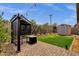 Backyard with a built-in grill, lush green grass, and mature landscaping at 1725 E Chanute Pass --, Phoenix, AZ 85040
