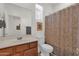 Standard bathroom featuring a toilet, vanity, mirror, and shower with patterned curtain at 1725 E Chanute Pass --, Phoenix, AZ 85040