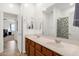 Bright bathroom with a double sink vanity, large mirror, and shower at 1725 E Chanute Pass --, Phoenix, AZ 85040
