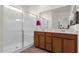 Bathroom with a walk-in shower, double sinks, and plenty of cabinet space at 1725 E Chanute Pass --, Phoenix, AZ 85040