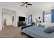 Carpeted bedroom featuring a black bed frame, nightstands, and plenty of natural light at 1725 E Chanute Pass --, Phoenix, AZ 85040