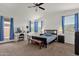 Bright bedroom with white walls, vaulted ceilings, a ceiling fan, and blue curtains at 1725 E Chanute Pass --, Phoenix, AZ 85040