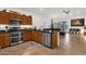 Open kitchen layout with stainless steel appliances and breakfast bar connecting to living area at 1725 E Chanute Pass --, Phoenix, AZ 85040