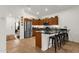Modern kitchen with stainless steel appliances, wood cabinets, black countertops, and bar seating at 1725 E Chanute Pass --, Phoenix, AZ 85040