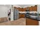Kitchen featuring stainless steel appliances, tiled flooring, and ample wood cabinet storage at 1725 E Chanute Pass --, Phoenix, AZ 85040