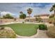 Wide backyard featuring artificial turf, rock landscaping, and swimming pool with lounge chairs at 17562 W Agave Ct, Goodyear, AZ 85338
