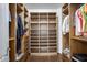 Spacious, custom walk-in closet with multiple shelving, drawers, and organization solutions at 17562 W Agave Ct, Goodyear, AZ 85338