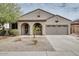 Charming single-story home with arched entryway, two-car garage, and low maintenance desert landscaping at 17562 W Agave Ct, Goodyear, AZ 85338