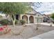 Charming single-story home with arched entryway and well-maintained desert landscaping at 17562 W Agave Ct, Goodyear, AZ 85338
