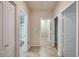 Bright hallway featuring neutral paint, tile floors and entryways to various rooms at 17562 W Agave Ct, Goodyear, AZ 85338