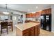 Spacious eat-in kitchen features an island, rich wood cabinetry and modern appliances at 17562 W Agave Ct, Goodyear, AZ 85338