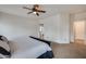 Bright and airy main bedroom with a ceiling fan and archway view into the en suite bathroom at 17562 W Agave Ct, Goodyear, AZ 85338