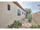 Side yard featuring desert landscaping, cactus, and rock ground cover at 17562 W Agave Ct, Goodyear, AZ 85338