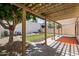 Inviting backyard with artificial grass, rock features, mature tree, and covered patio with pergola at 18031 N 12Th Pl, Phoenix, AZ 85022