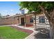 A backyard featuring a covered patio, artificial turf, and decorative landscaping at 18031 N 12Th Pl, Phoenix, AZ 85022