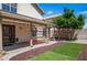 Backyard showcasing covered patio, artificial turf, desert landscaping and potted plants at 18031 N 12Th Pl, Phoenix, AZ 85022