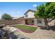 Beautifully landscaped backyard with artificial turf, decorative rocks, covered patio and pond at 18031 N 12Th Pl, Phoenix, AZ 85022