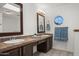 Bright bathroom with double sinks, tile countertops, and unique round window for natural light at 18031 N 12Th Pl, Phoenix, AZ 85022