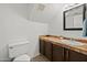 Bathroom features a single sink vanity with tile countertops, and a toilet at 18031 N 12Th Pl, Phoenix, AZ 85022