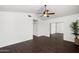 A bright bedroom featuring dark floors, a modern ceiling fan, and a spacious closet with sliding mirrored doors at 18031 N 12Th Pl, Phoenix, AZ 85022