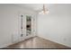 Bright dining area with tile floors, large windows, and a modern chandelier at 18031 N 12Th Pl, Phoenix, AZ 85022